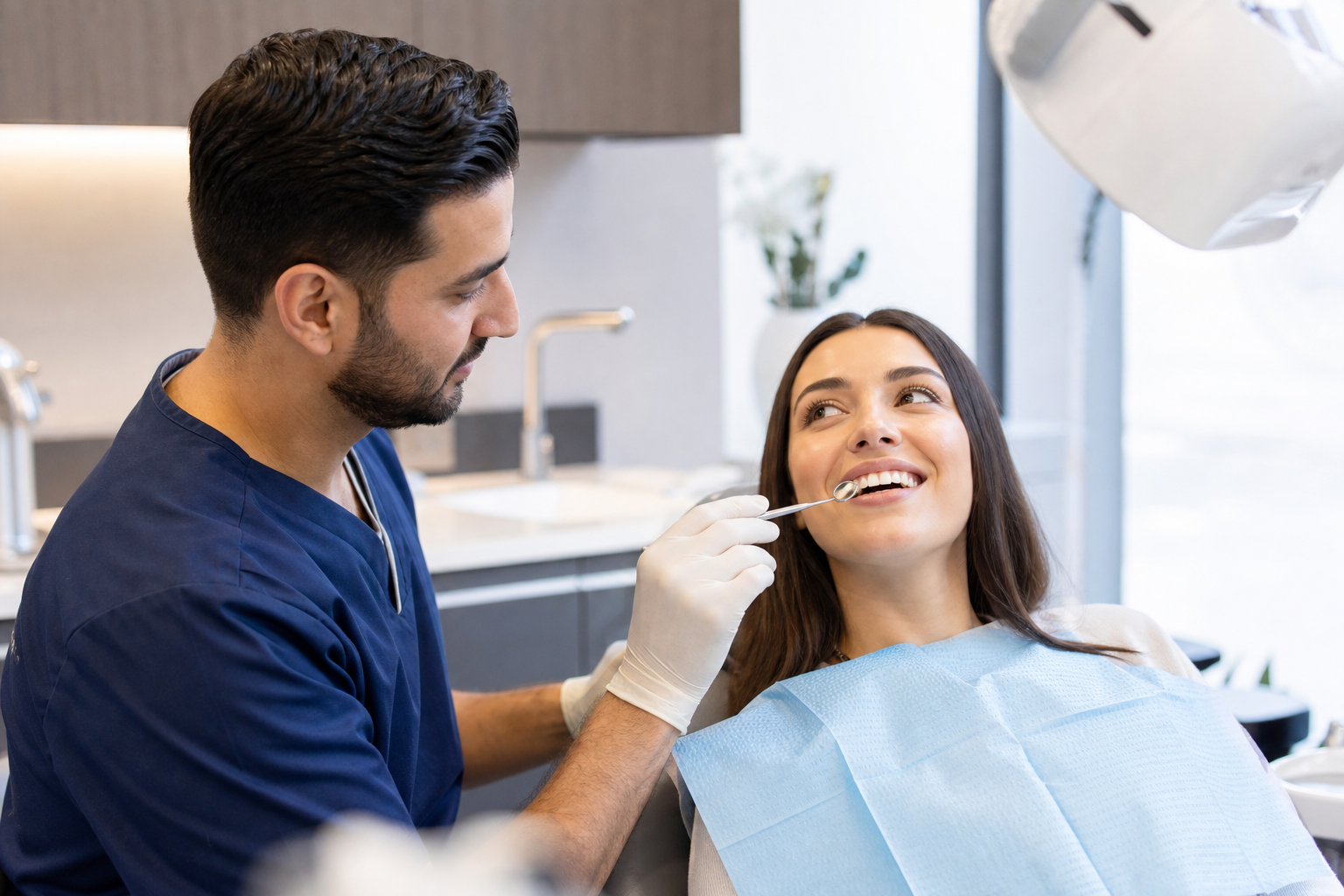 Dentist examining a patient's front teeth to assess suitability for composite bonding